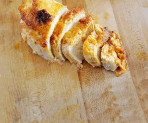 baked chicken breast on a cutting board